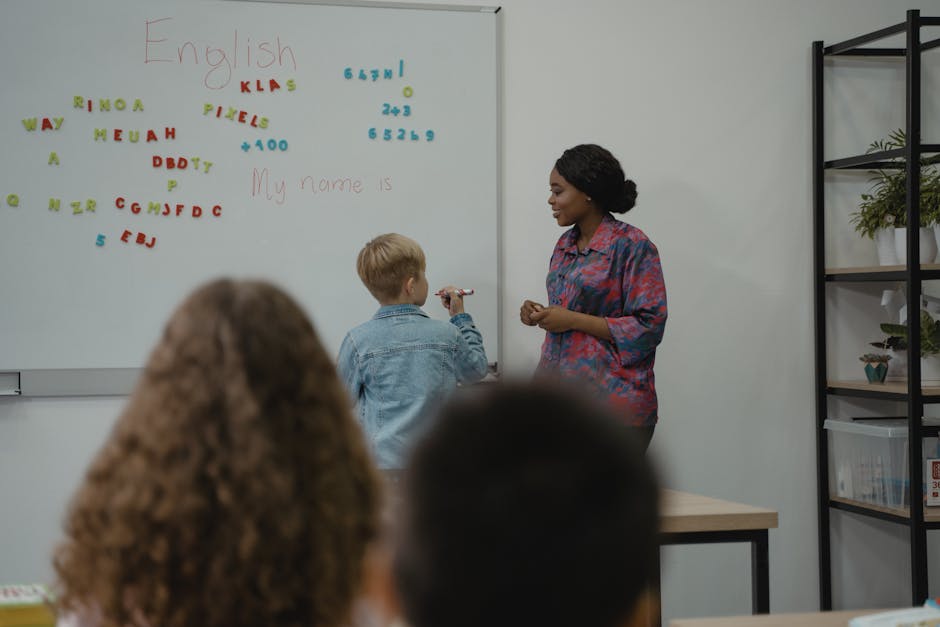 A teacher engages students in an interactive English lesson using a whiteboard and magnetic letters